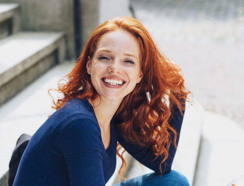 women smiling with healthy gums and teeth