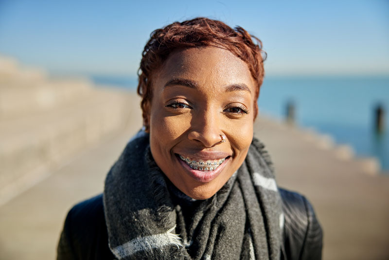 Women smiling with braces on her teeth